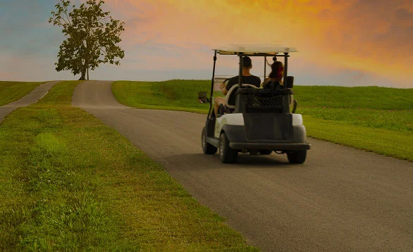 People riding in golf cart
